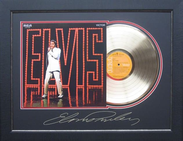 Framed gold record displayed beside the Elvis Presley album cover with a laser-reproduced signature, offered as a charity auction lot