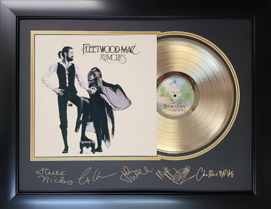 Framed gold record displayed beside the Fleetwood Mac Rumours album cover with a laser-reproduced signature, offered as a charity auction lot