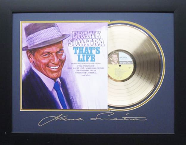 Framed gold record displayed beside the Frank Sinatra That's Life album cover with a laser-reproduced signature, offered as a charity auction lot