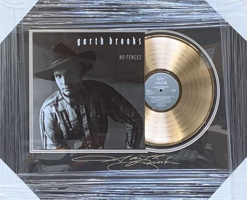 Framed gold record displayed beside the Garth Brooks No Fences album cover with a laser-reproduced signature, offered as a charity auction lot
