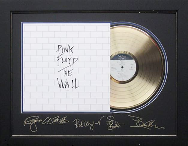 Framed gold record displayed beside the Pink Floyd The Wall album cover with a laser-reproduced signature, offered as a charity auction lot