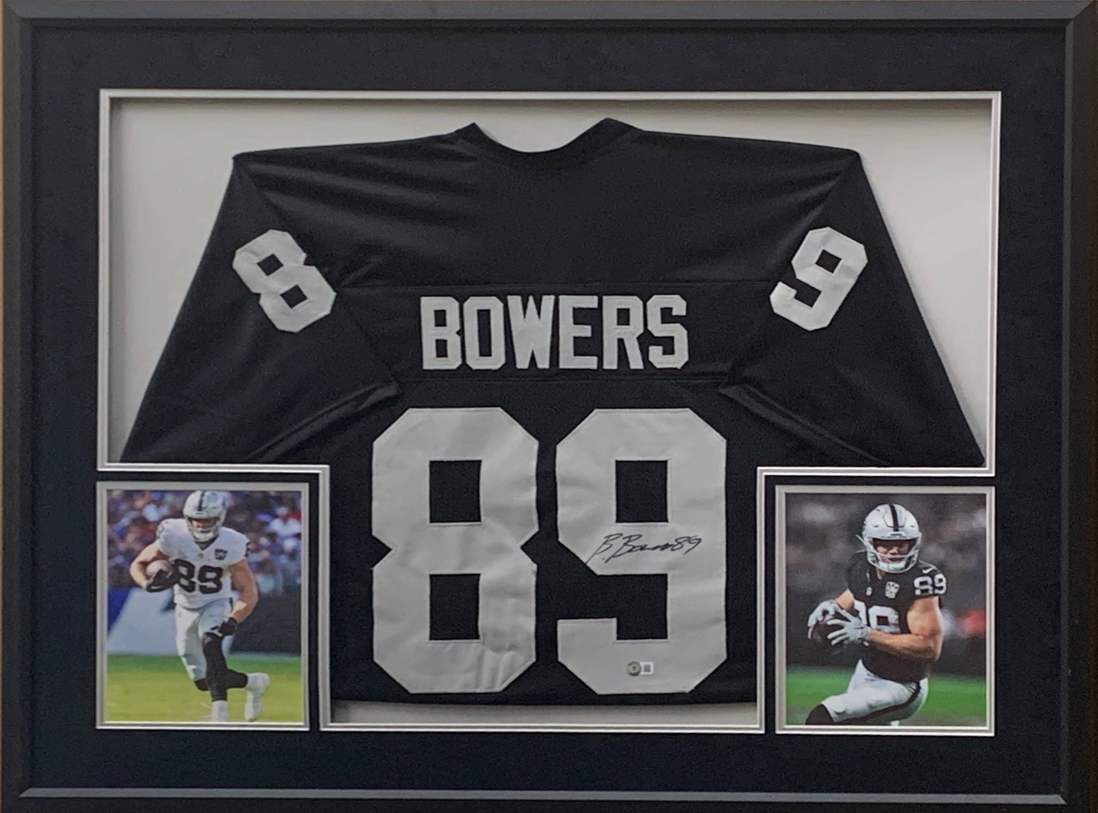 Black and silver Las Vegas Raiders jersey hand-signed by Brock Bowers, framed with action photographs, offered as a charity auction lot