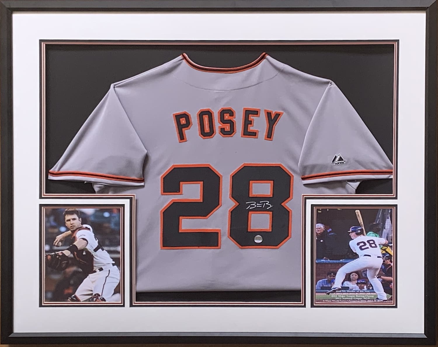 Cream and orange San Francisco Giants jersey hand-signed by Buster Posey, framed with action photographs, offered as a charity auction lot