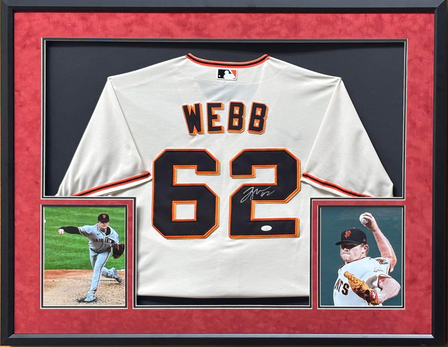 Cream and orange San Francisco Giants jersey hand-signed by Logan Webb, framed with action photographs, offered as a charity auction lot