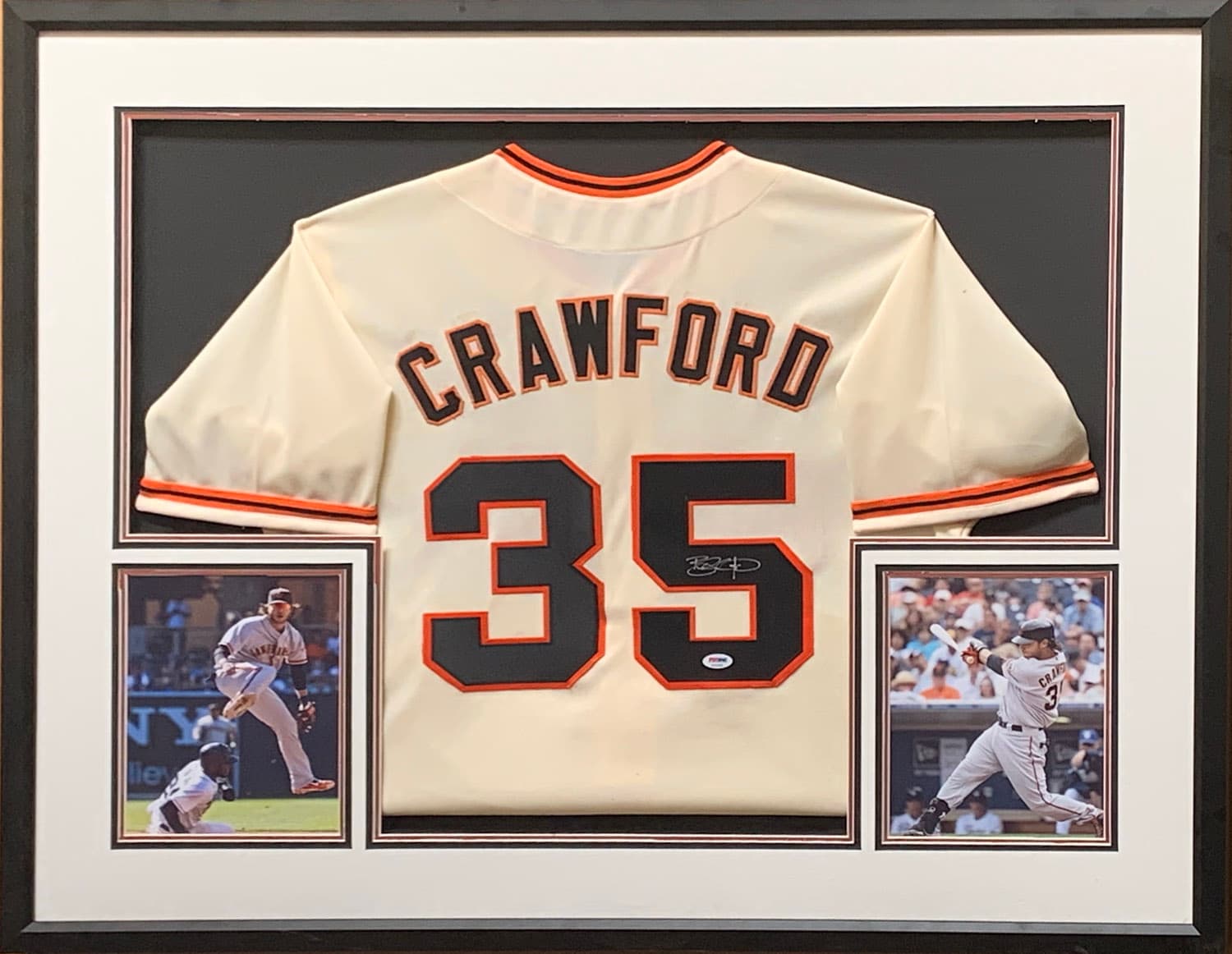 Cream and orange San Francisco Giants jersey hand-signed by Brandon Crawford, framed with action photographs, offered as a charity auction lot