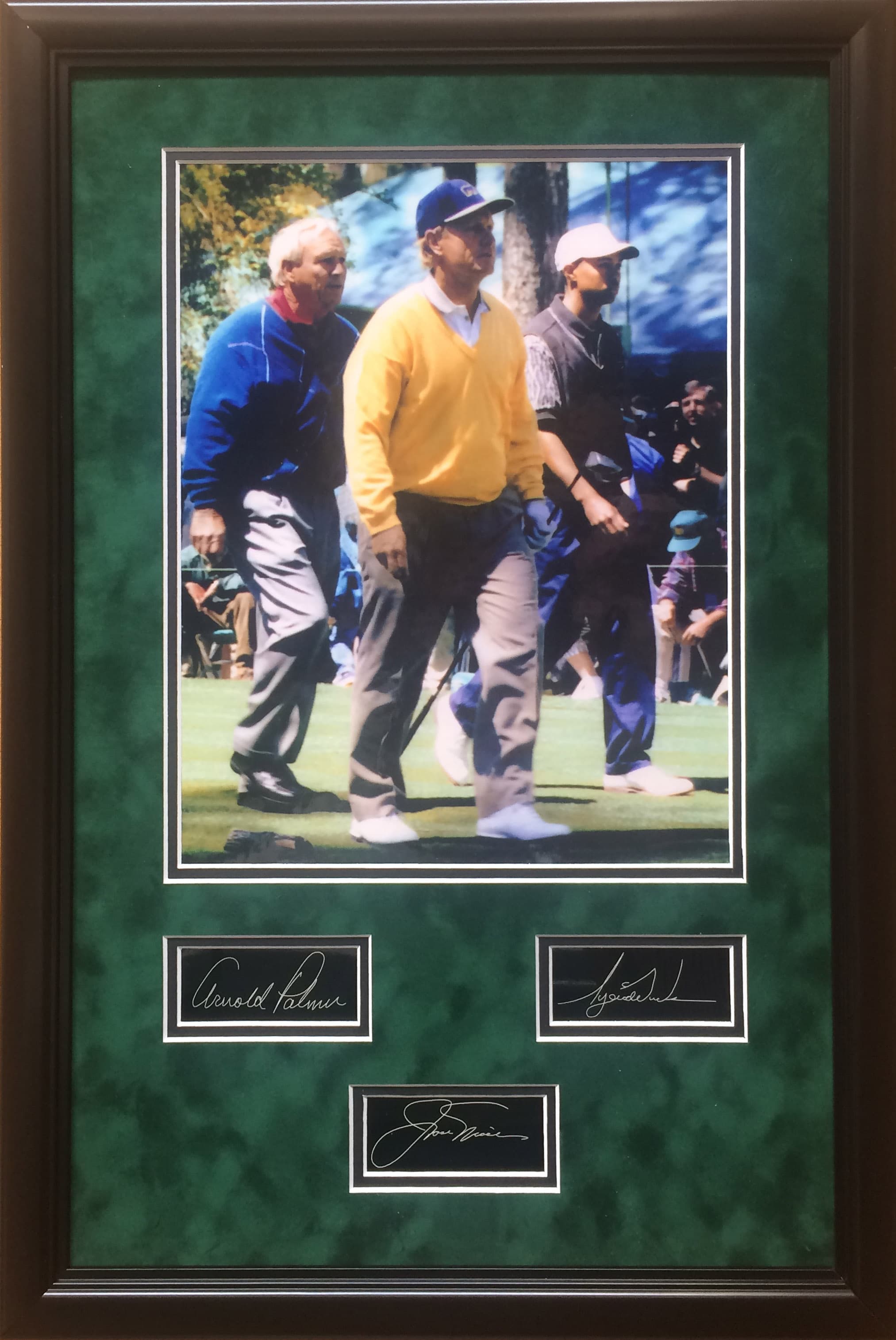 Framed golf commemorative featuring Palmer, Nicklaus and Woods with laser-reproduced signatures, a charity auction lot
