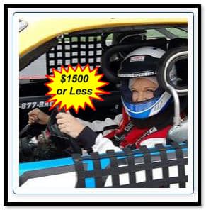 Driver in helmet and harness at the wheel of a stock car, representing the NASCAR driving experience auction lot