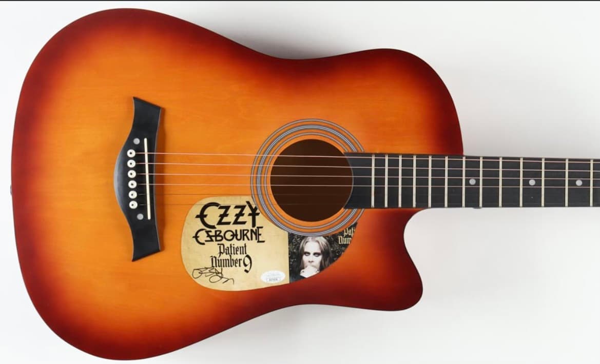Sunburst acoustic guitar hand-signed by Ozzy Osbourne with tour artwork on the body, a fundraiser auction lot