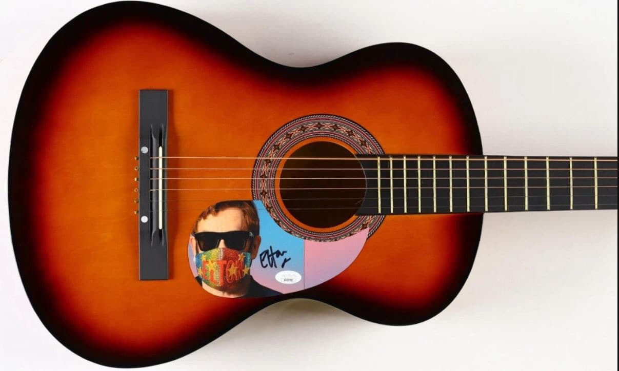 Sunburst acoustic guitar hand-signed by Elton John with colourful portrait artwork on the body, a fundraiser auction lot